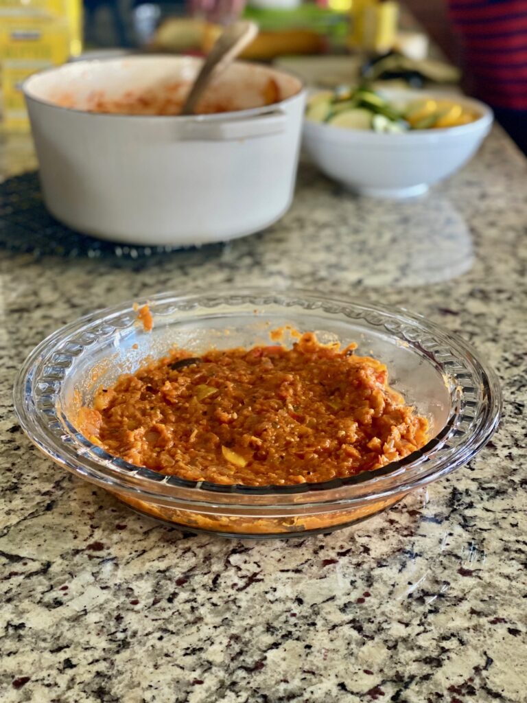 Tomato sauce at the bottom of a pie dish