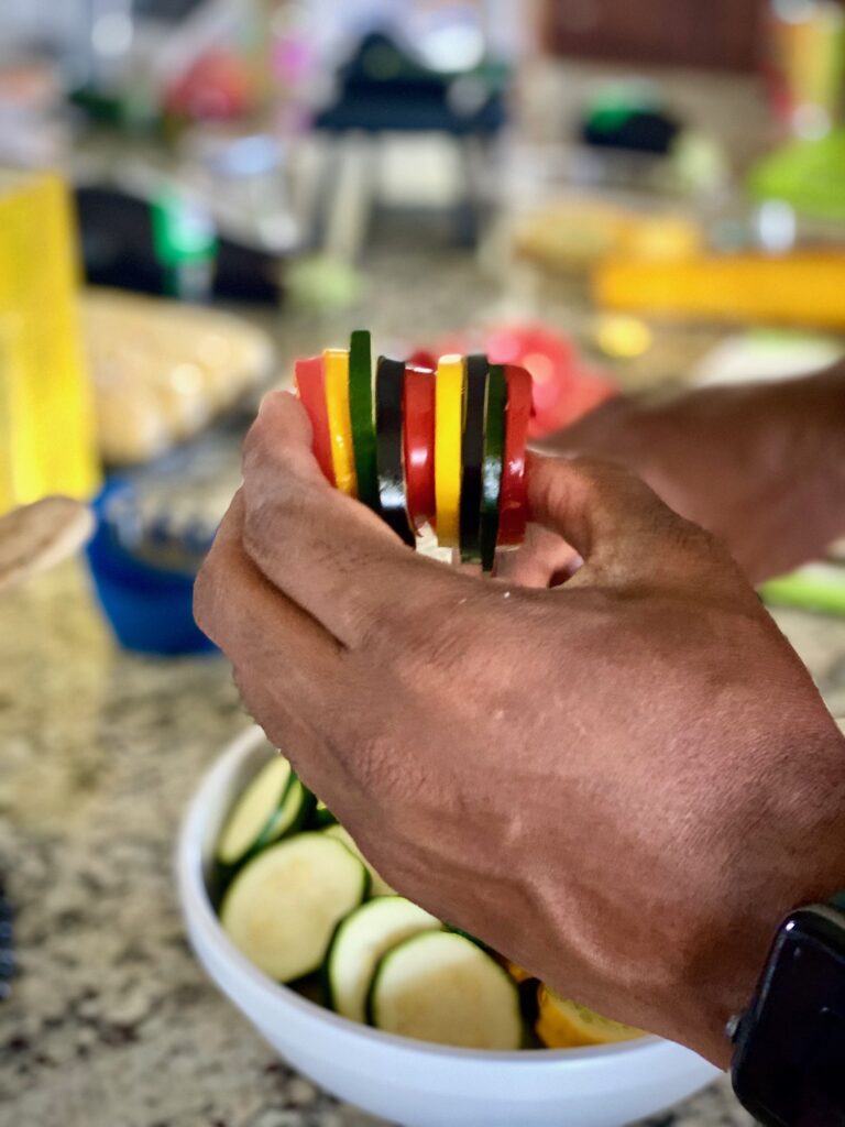 Chef gathering alternating vegetable slices in his hands