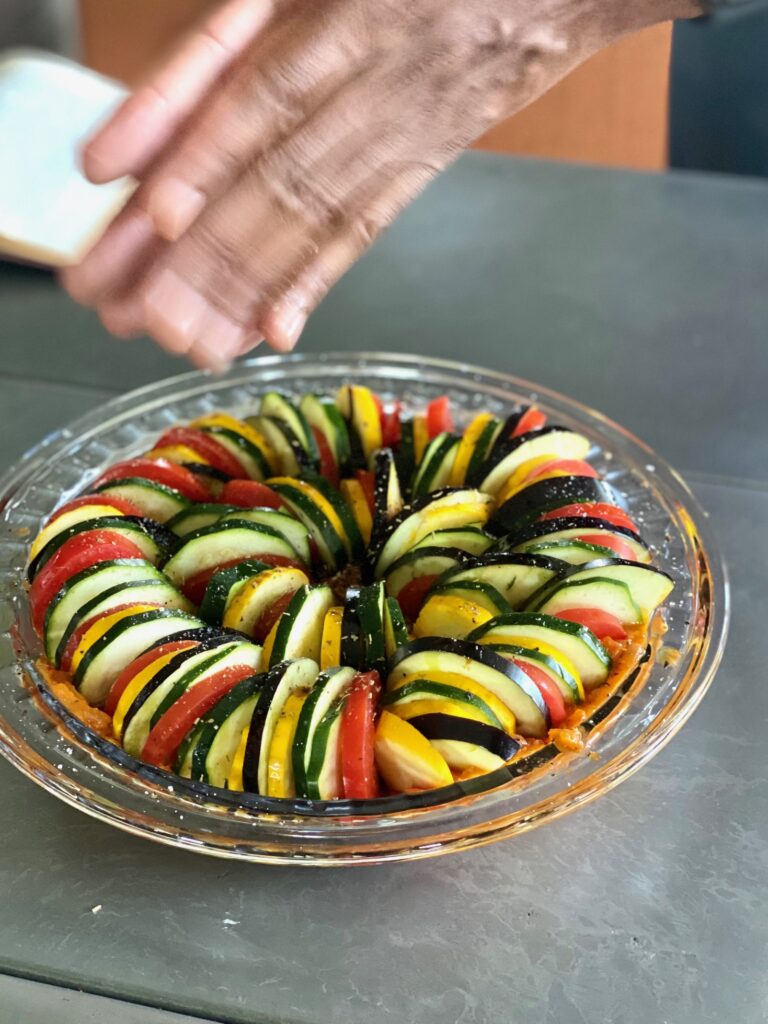 Sliced vegetables in sauce arranged in a circular manner