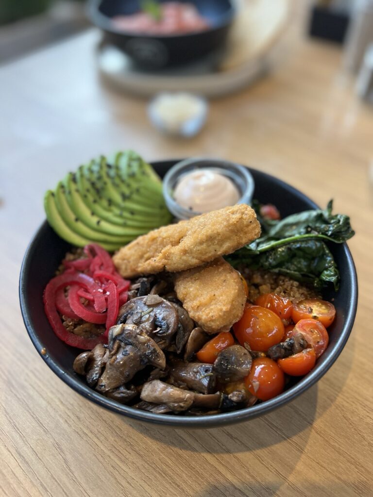 bow with chicken fingers, sautéed mushrooms, tomatoes, spinach, sliced avocado, pickled onions