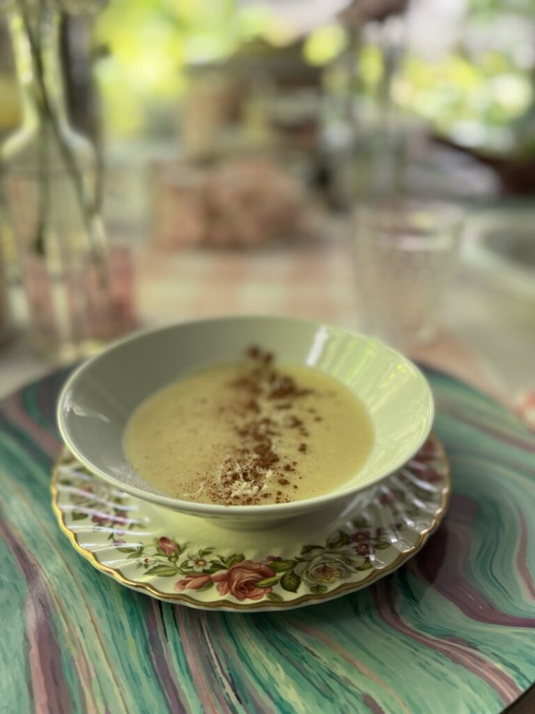 A bowl of cornmeal porridge on a table with a printed mat.