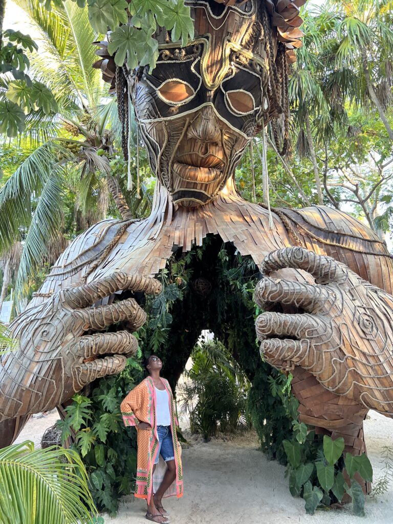 Woman standing in front of huge art installation