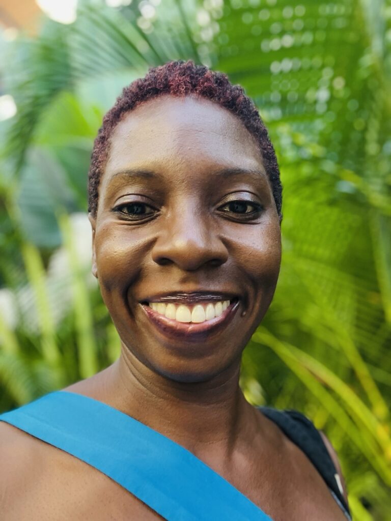 Selfie of woman with tropical palms in background