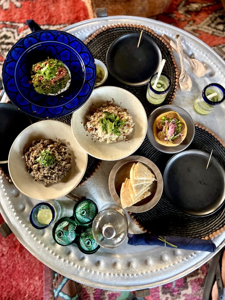 Overhead view collection of plates with a variety of foods.