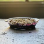 Picture of Very Berry Crisp on a table with a window in the background.