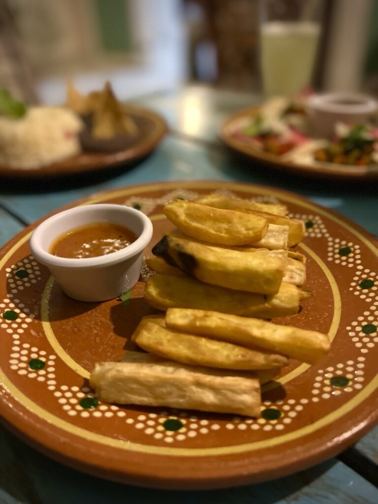 a plate with yucca fries and sauce