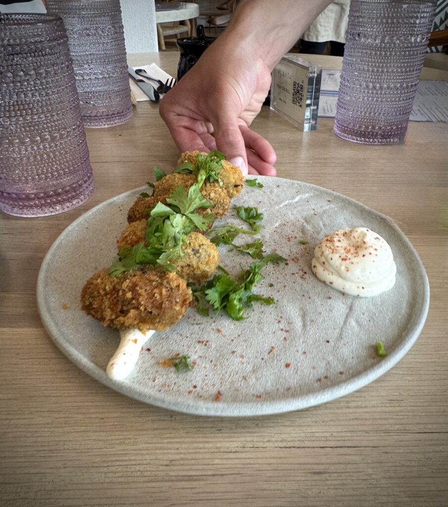 Croqueta on a plate with micro greens