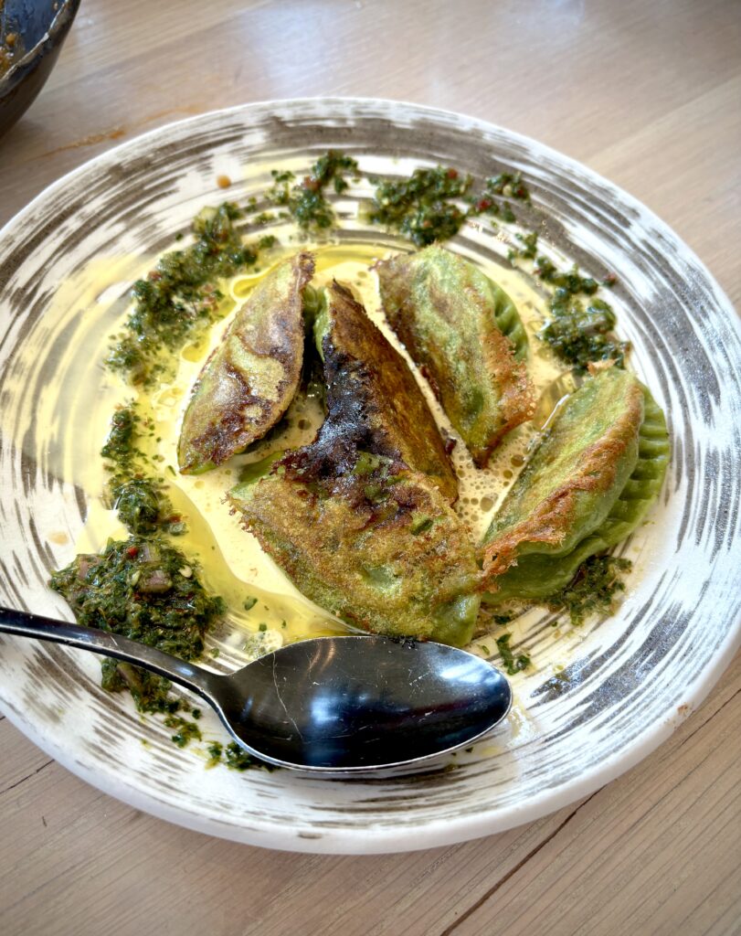 Gyoza dumplings topped with chimichurri sauce