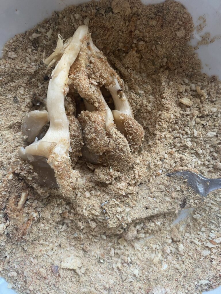 Oyster mushroom dredged in seasoned flour mixture.