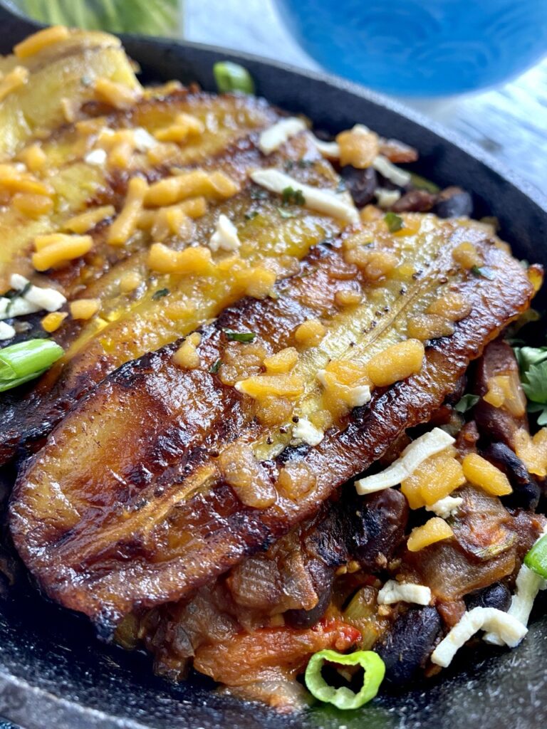 Close up of baked pastelon in cast iron casserole.