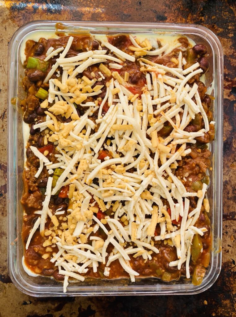 Overhead view of unbaked pastelon in a casserole dish. 