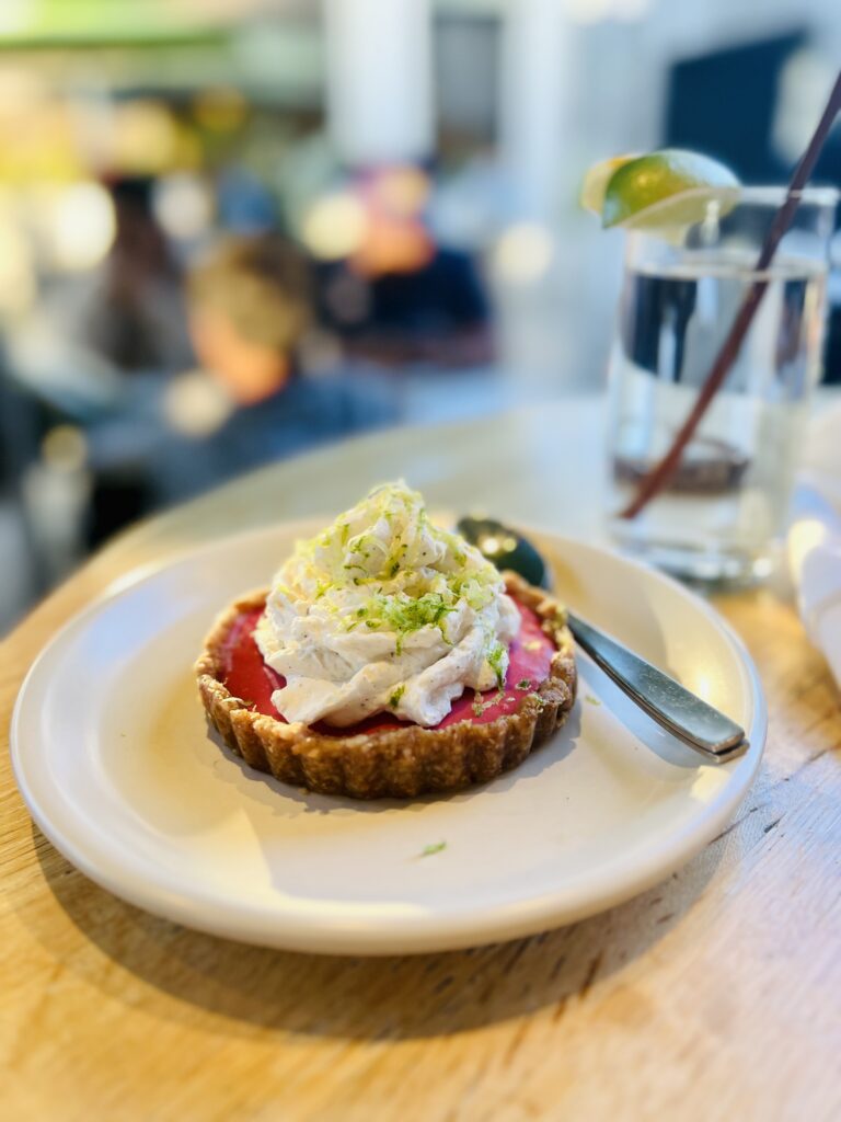 Ube Lime Tart with coconut whip on top.
