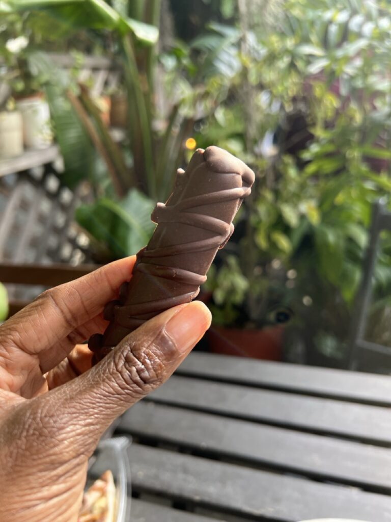 Hand holding a raw vegan Twix bar