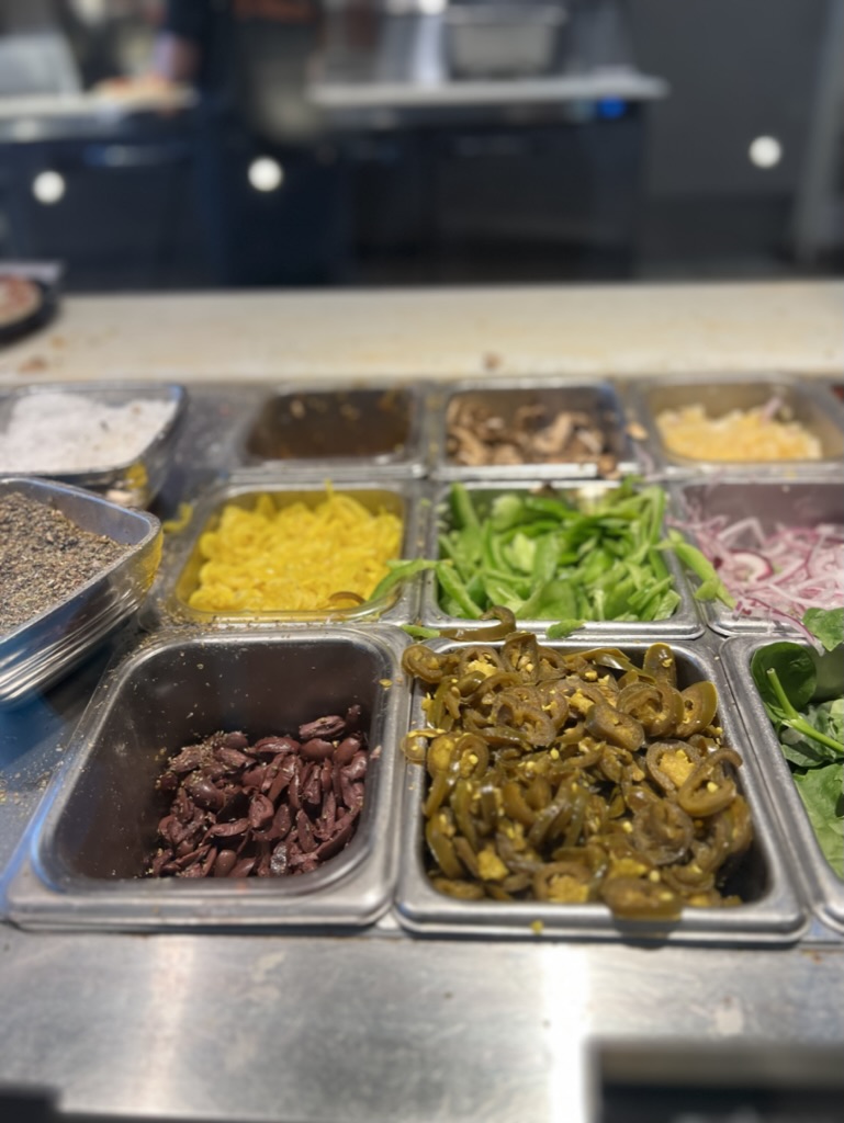 Image of various toppings at Blaze Pizza restaurant.