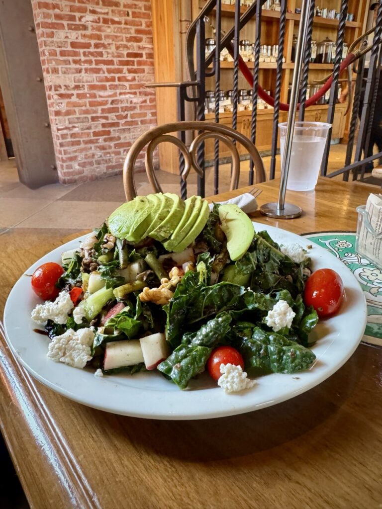 Urth Caffe Paradise salad with kale, grape tomatoes, walnuts, wild rice, avocado, and vegan cheese.