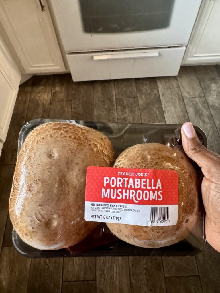 Two ortabella mushroom caps in shrink wrap package.