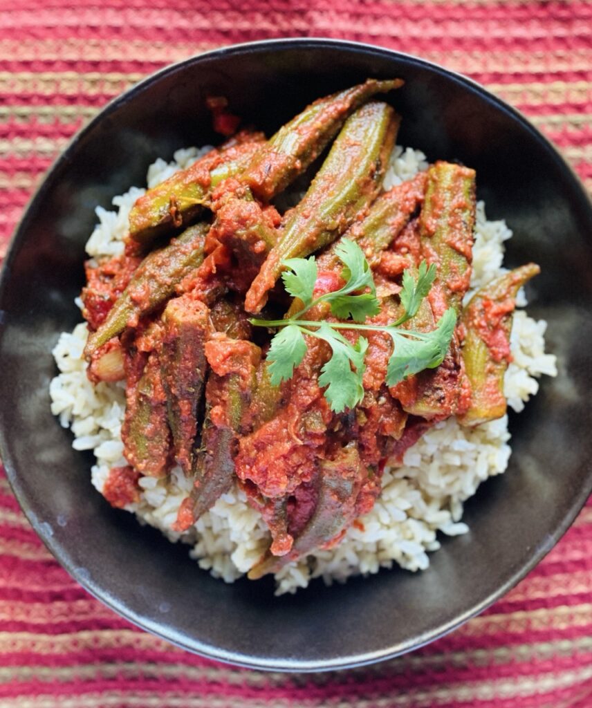 Okra cooked in tomato stew on a bed of brown rice.