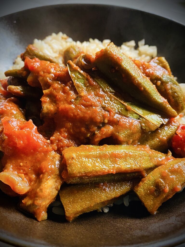 Okra cooked in tomato stew on a bed of brown rice.