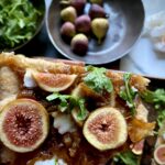 Fig flatbread pizza with arugula and caramelized onions.