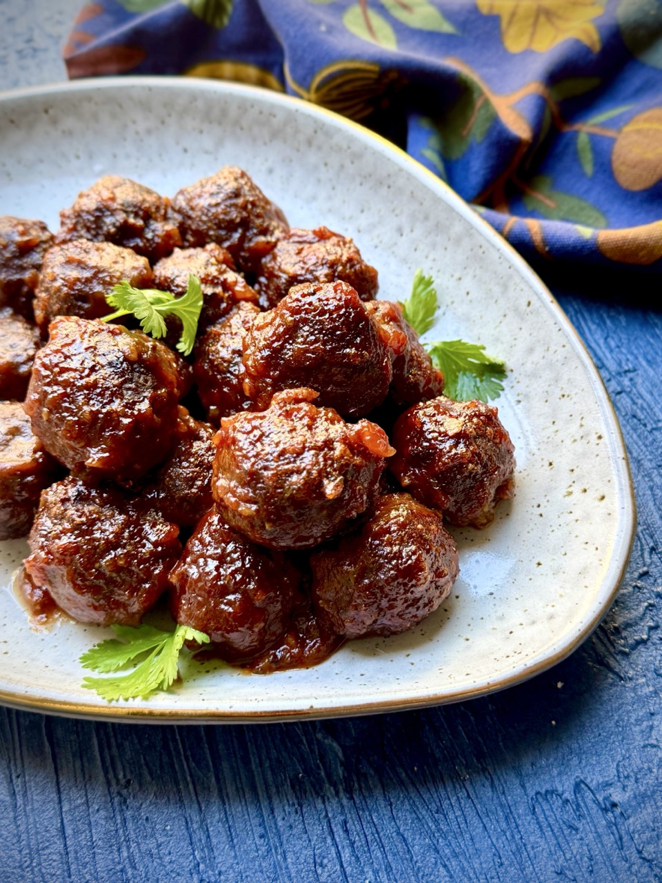 A platter of walnut meatballs glazed in apricot barbecue sauce.